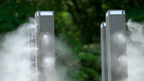 close-up outdoor misting cooling water spraying system with nozzle sprinklers on metal poles in public yangjae foret park in seoul, south korea