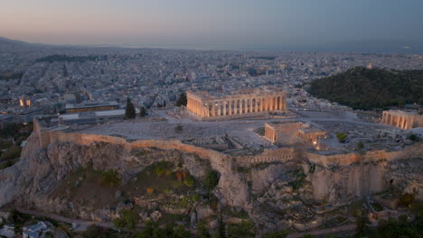 descending pan up aerial shot of the lit up acropolis athens greece