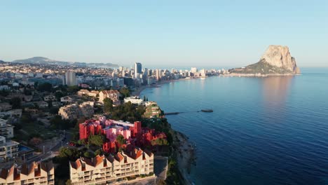 Golden-sunrise-over-Alicante-coast-with-Penon-de-Ifach,-aerial-view