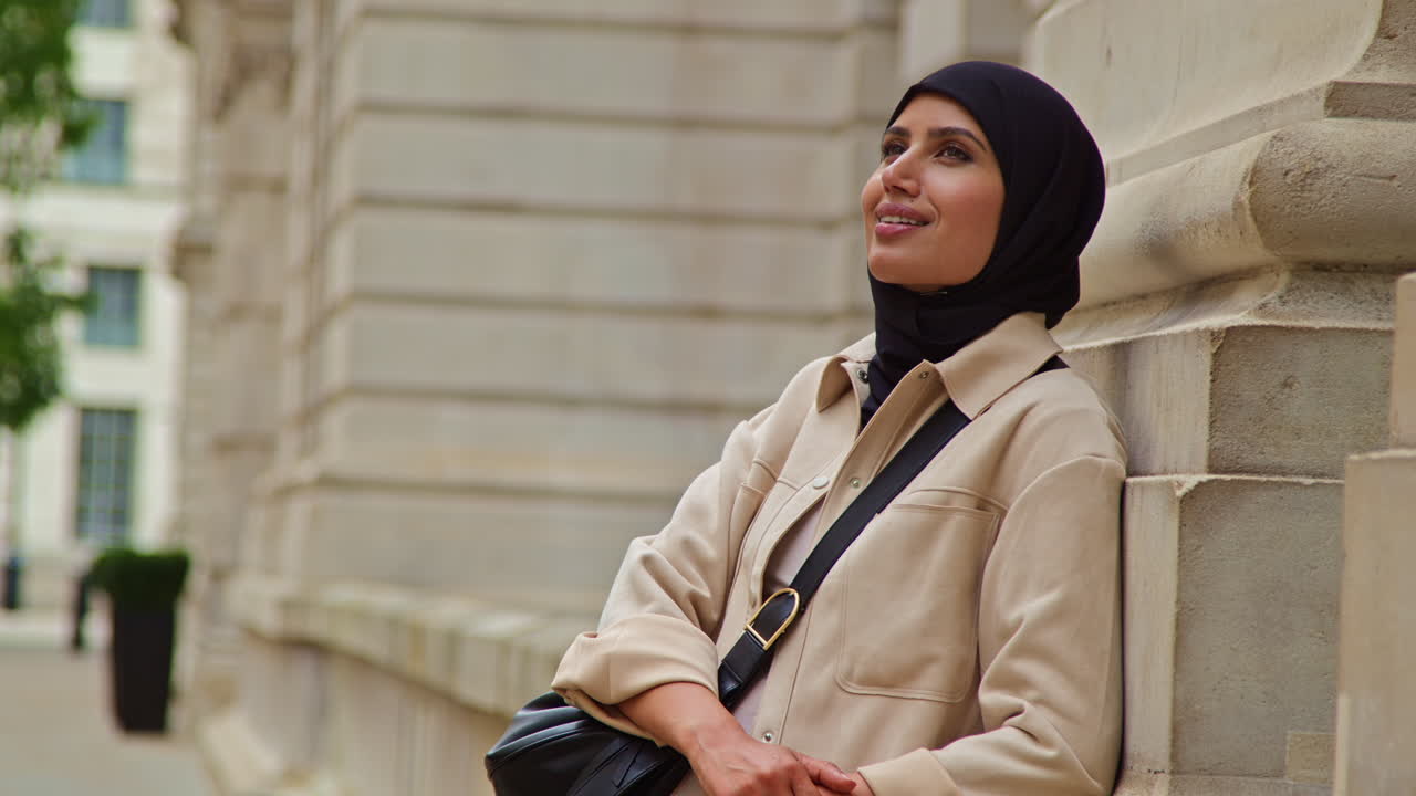 Portrait Of Smiling Muslim Businesswoman Wearing Hijab And Modern Business Suit Standing Outside City Office Buildings 1