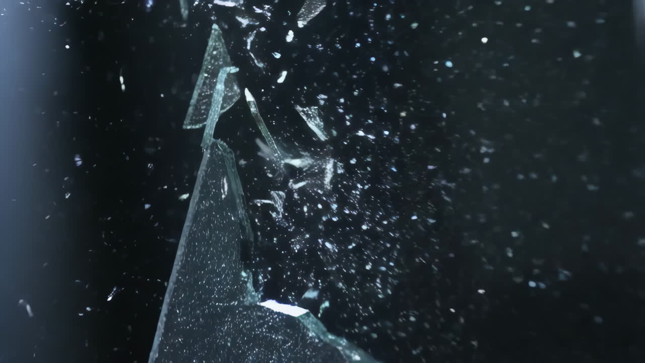 Shattering Glass Fragments on a Dark Background