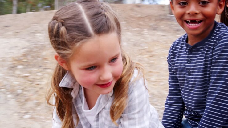 Bambini delle elementari che girano su una giostra all'aperto