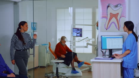 dentist inviting senior man in consultation dental room