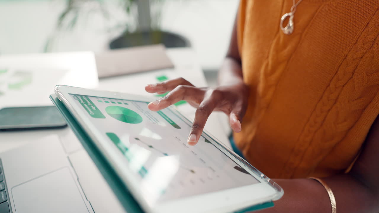 Close-Up of Hands Analyzing Data on a Digital Tablet