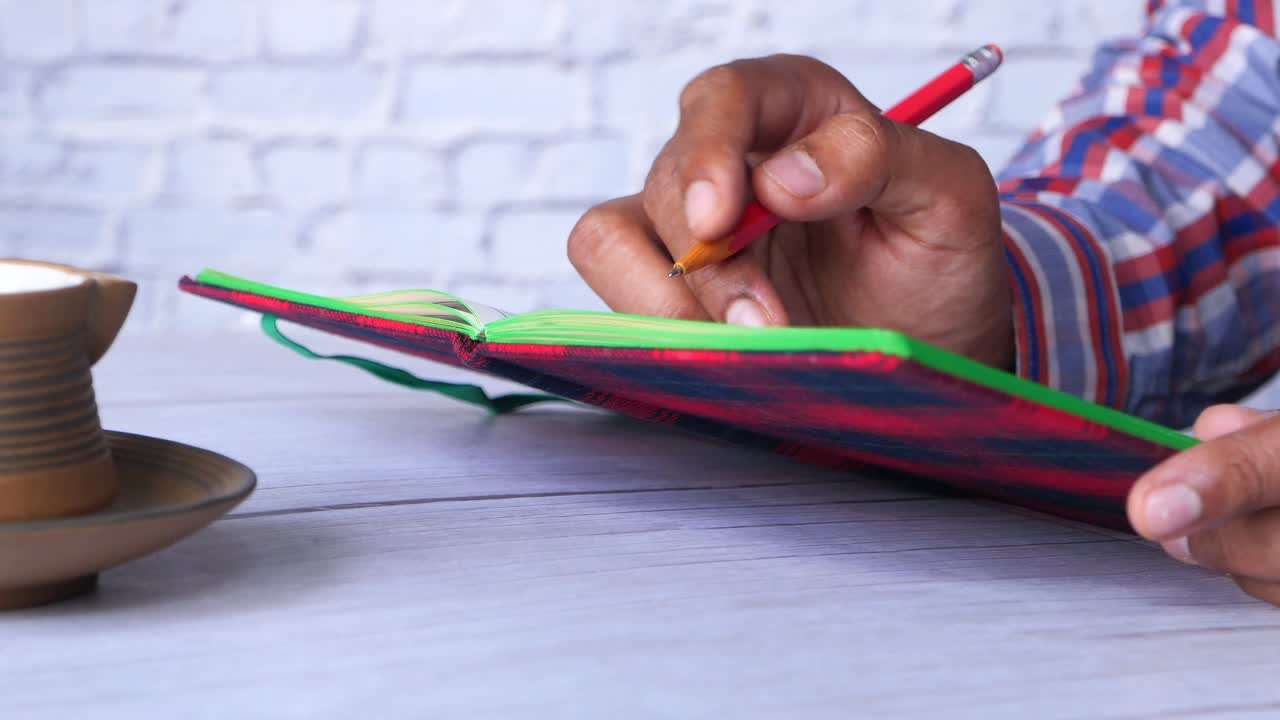 persona que escribe en un cuaderno