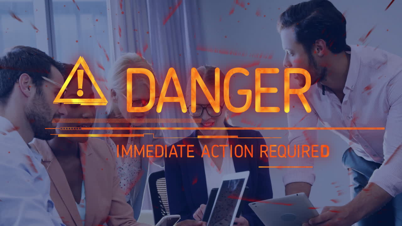 Danger warning text animation over business meeting with diverse professionals
