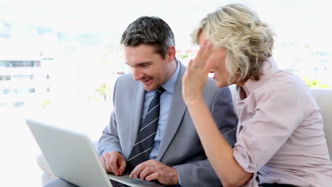 business people working together on laptop