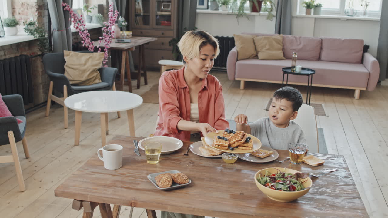 Asian Mom and Son Having Breakfast Together at Home