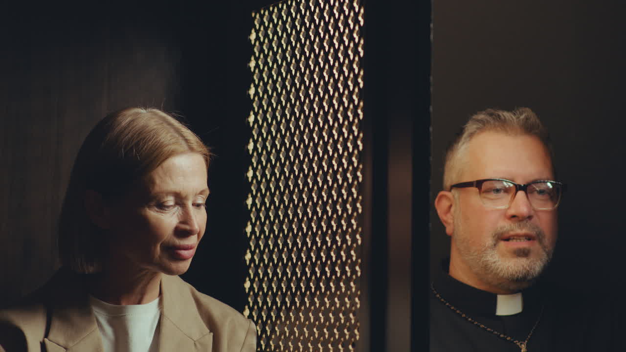 Priest and Senior Woman Having Conversation during Confession