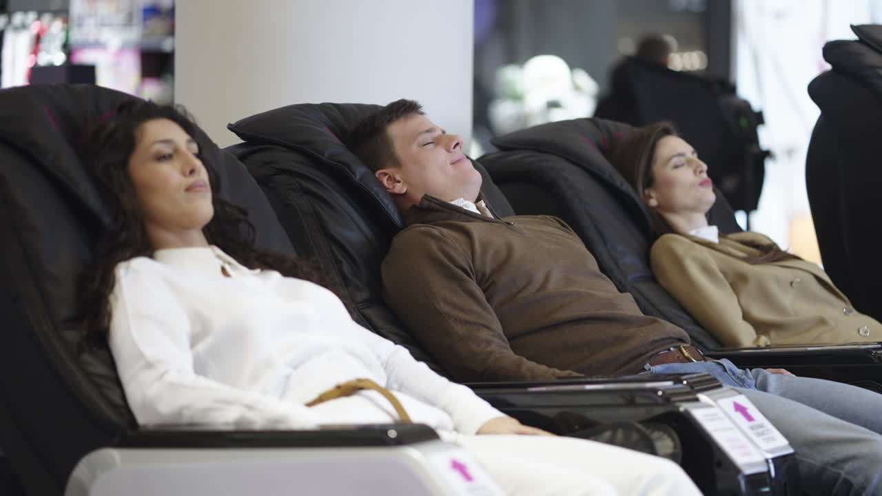 People relaxing in massage chairs