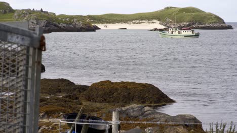 Static-shot-of-a-yacht-anchored-in-the-bay-near-a-beach-on-Bernera