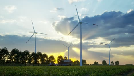 wind turbines standing in sunset. farm with wind turbines. generating clean renewable energy. bright orange sunset. alternative energy