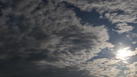 Night-sky-timelapse-with-the-moon,-stars-and-moving-clouds