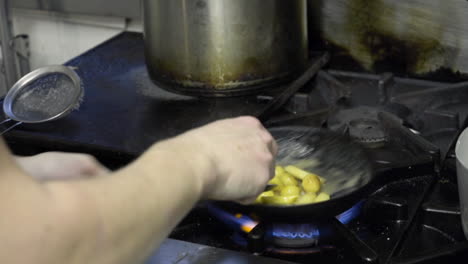 fresh agnolotti pasta in frying pan with parsnips and potatoes finished with butter wide shot