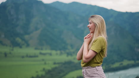 happy woman tourist enjoys mountain valley view at resort