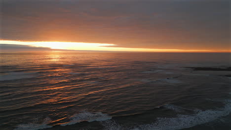 establishing aerial drone shot of sunrise over sea at cleveland way in north yorkshire