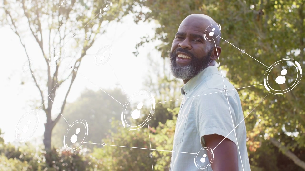 African American male turning toward camera in park with sunlight, trees, shirt, digital overlays