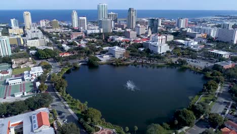 4k aerial video of downtown st petersburg, florida from mirror lake - tilt up from fountain