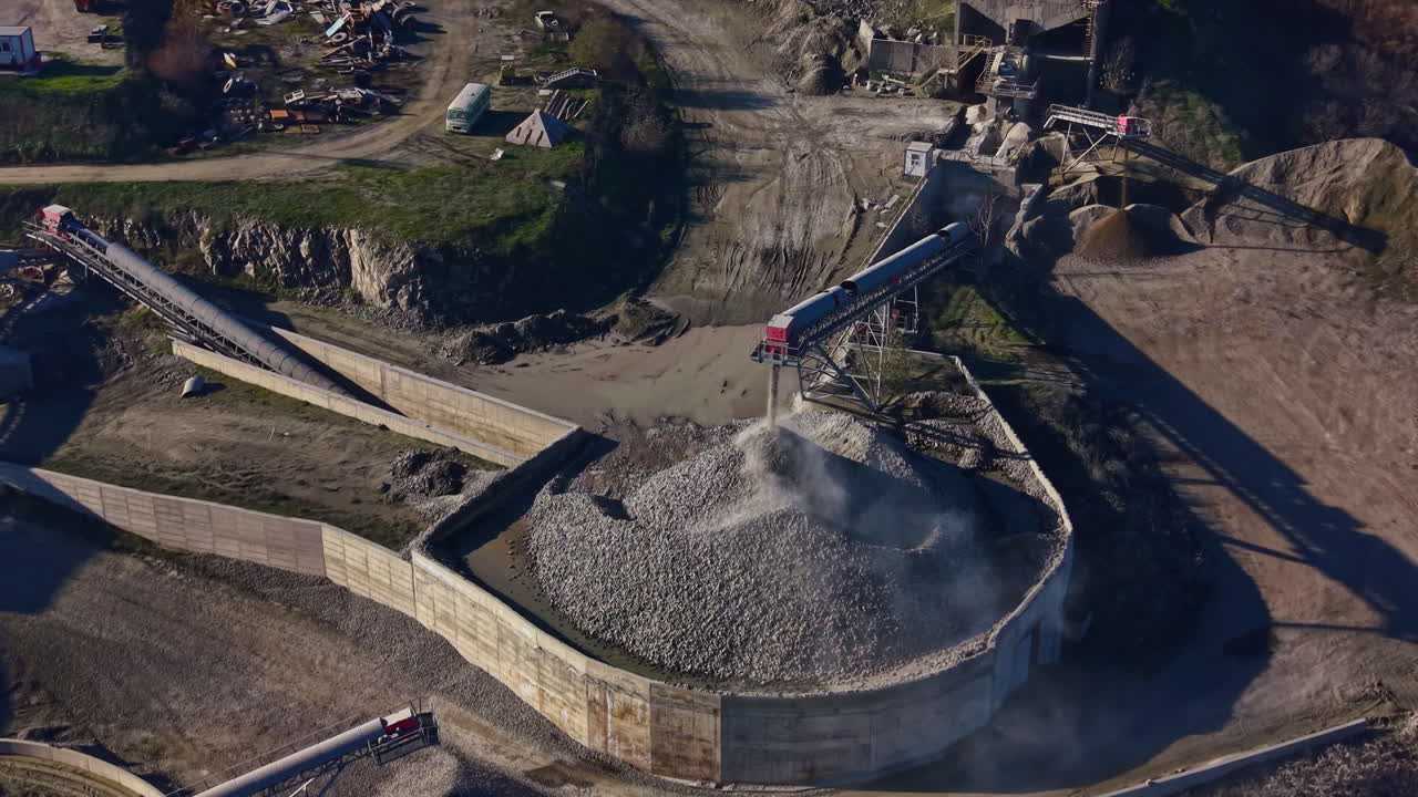 Industrial landscape showcasing a stone processing area with equipment working diligently under clear blue skies