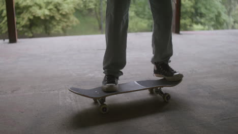 caucasian boy skateboarding in a ruined building.