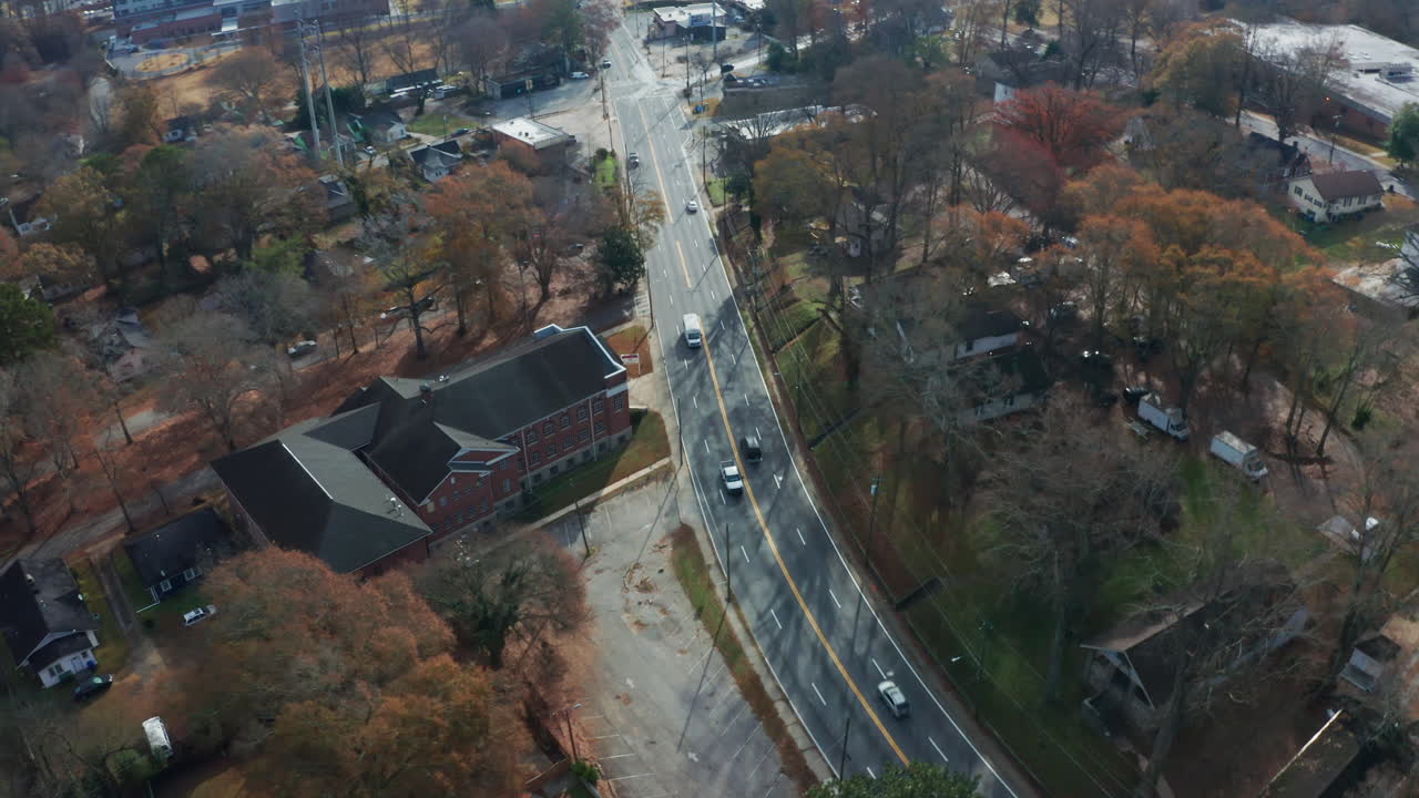 A dynamic overhead shot over drivers and pedestrians on busy Northside Drive, a popular commuter road and state highway, on the westside of Atlanta, Georgia during the fall.