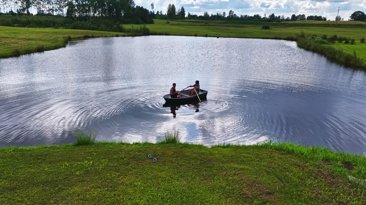 Couple on small boat calm body of water pond lake rural nature outdoor leisure activity