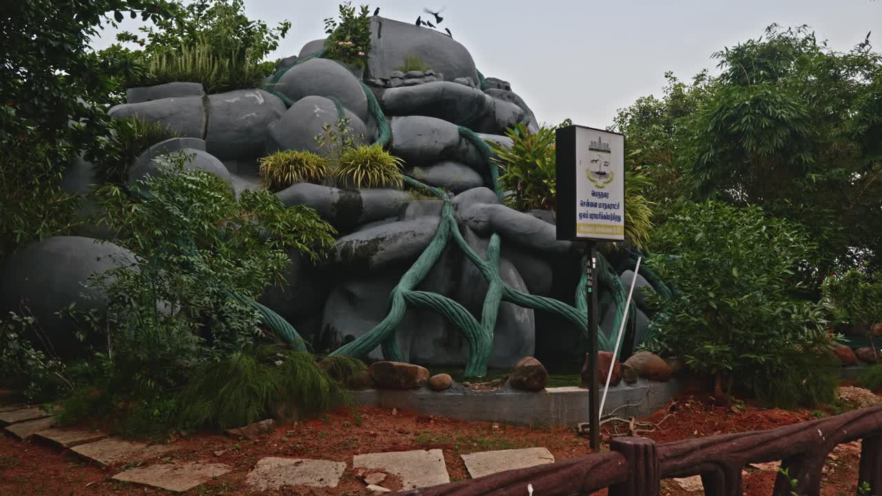 Artificial Water Falls with crows and trees at beach road, marina beach, chennai, tamil nadu, india. day time, stable shot, 4k.