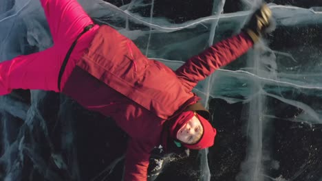 la chica hace un beso en el aire, se acuesta en el hielo, el dron se aleja de ella, girando en espiral.