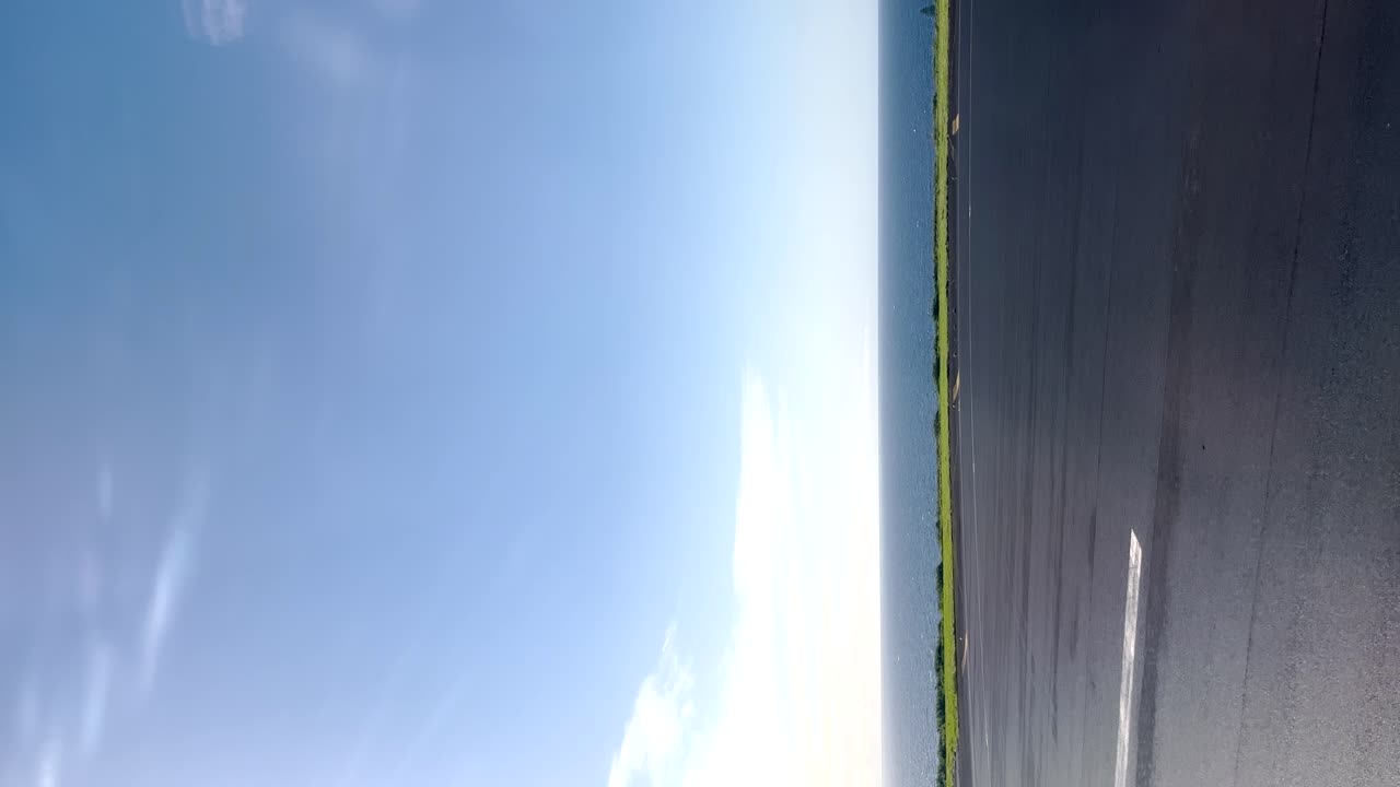 수직 비디오는 은 날 비행기의 창 아래로 굴러가는 활주로를 포착하여 여행과 휴가의 정신을 상징합니다.