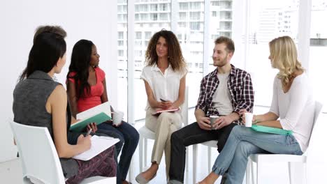 cheerful psychologist leading group of people