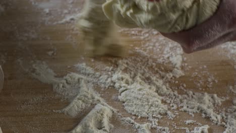 kneading dough on a wooden surface