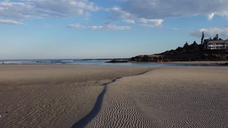 drone fly above sandy beach in ogunquit maine usa while seagull fly above the atlantic ocean water during a sunny day of summer revealing scenic coastline