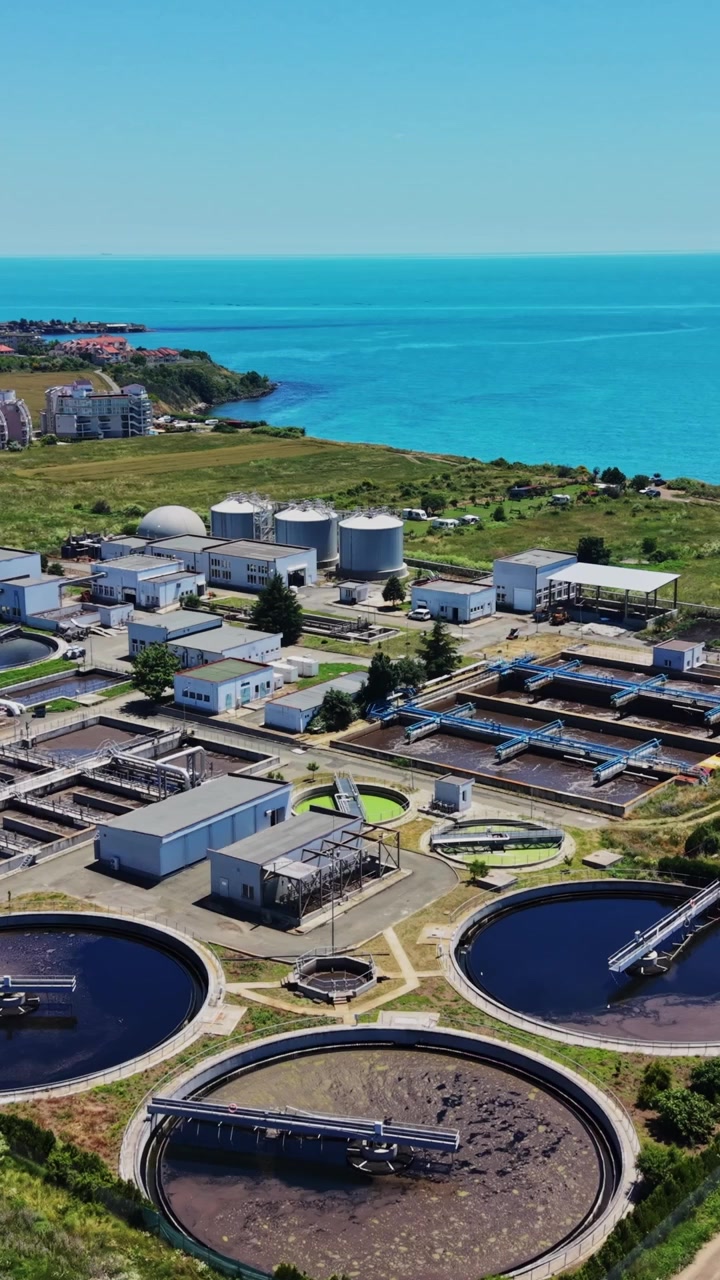 Industrial water treatment facility near coastline on a sunny day