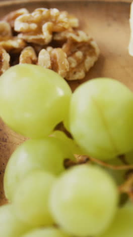 slices of cheese with walnuts, grapes and jam