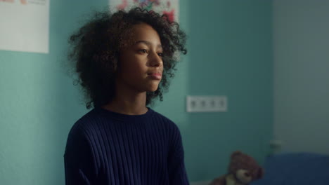 african american girl talking with unknown doctor sitting hospital close up.