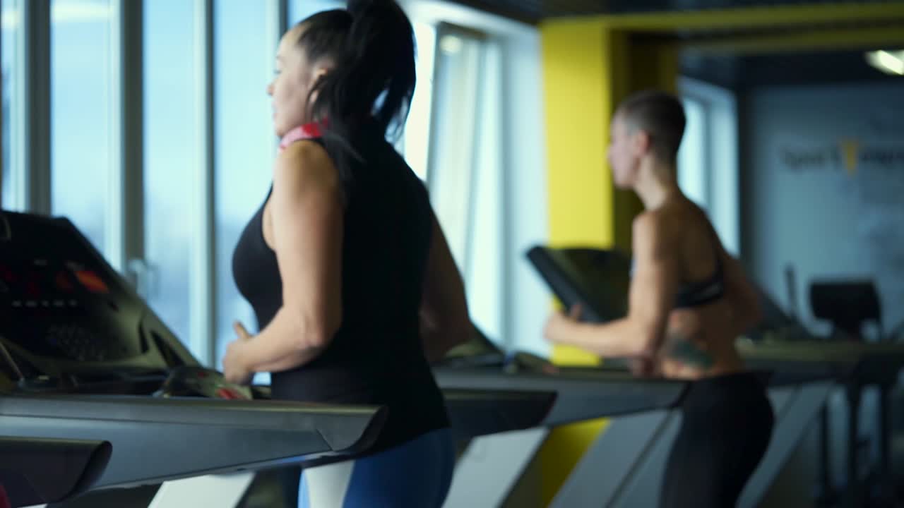 Women Exercising on Treadmills in Gym