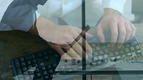 Businessman-reading-newspaper-at-airport-against-person-typing-on-keyboard