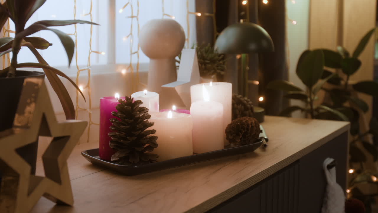 Festive Holiday Decorations with Candles and Pine Cones