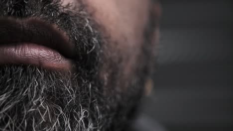 Close-up-of-a-bearded-Black-man-intently-looking-at-a-screen