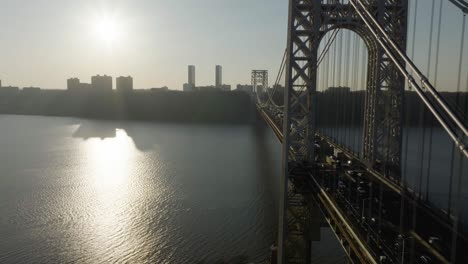 Vista-Aérea-Volando-En-Paralelo-Al-Puente-George-Washington,-Puesta-De-Sol-Sobre-Jersey,-Estados-Unidos---Reversa,-Disparo-De-Drone