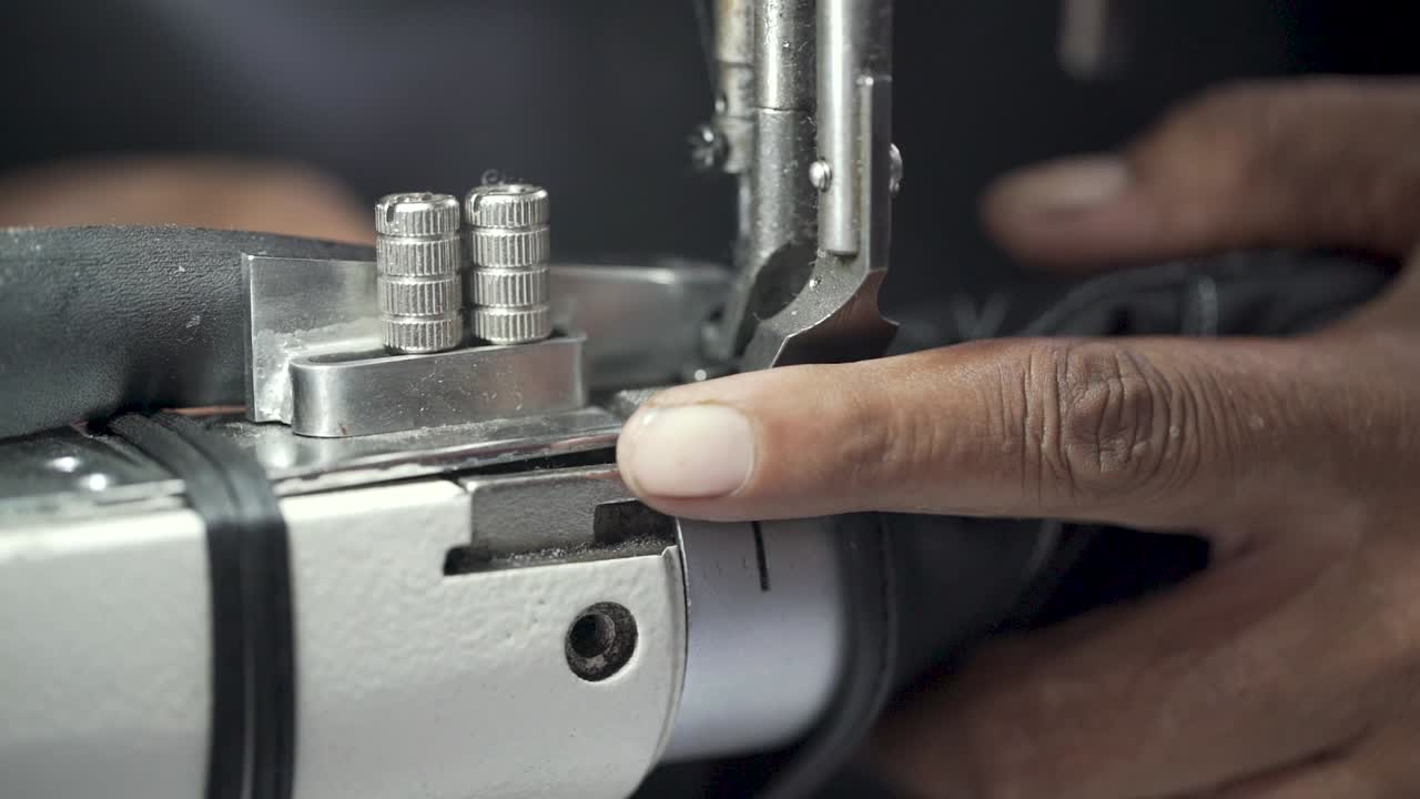 Closeup Shot Of A Tailor Stitching Leather, Sewing Machine In Clothing Production