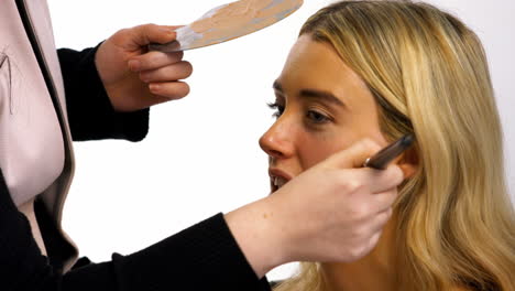 make up artist applying make up