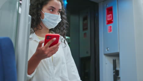 woman on a train using her smartphone