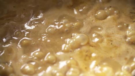 bubbling pot of fish curry