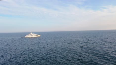 aerial over a large white private yacht cruising on the high seas 1