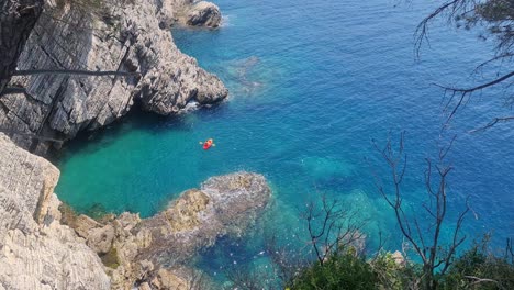 young man kayaking alone at sea