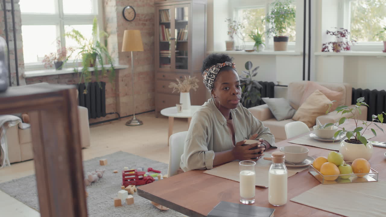 Black Woman Enjoying Breakfast in Loft Apartment