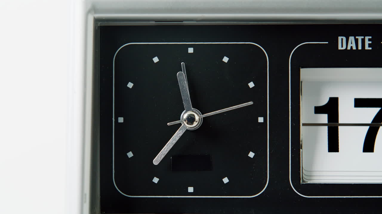 Flip clock arrow moving circle macro view. Vintage mechanical clock showing time