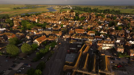 sunlit houses and medieval buildings in rye town during sunset in east sussex, england, uk. - aerial shot