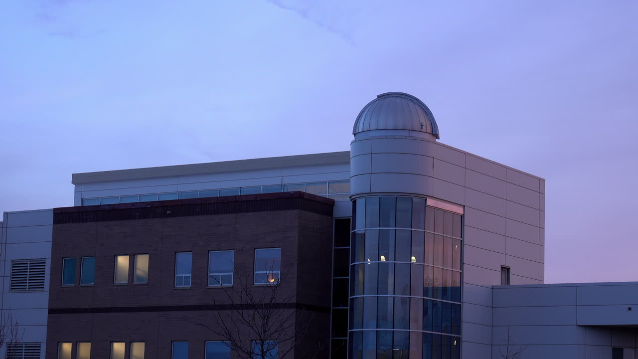 Building with astronomical observatory at dusk.
